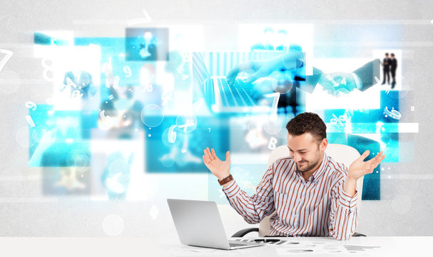 Business person at desk with modern tech images at background