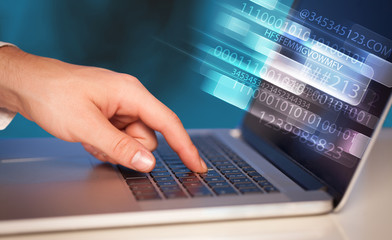 Obraz na płótnie Canvas Close up of man typing on laptop computer