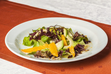 Orange, avocado and purple lettuce salad