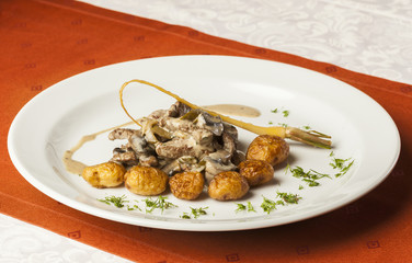 Beef in mushroom sauce served with roasted new potatoes
