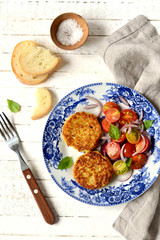 zucchini patties and fresh salad in a vintage plate 