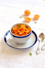 apricot jam in a vintage Cup on a light surface