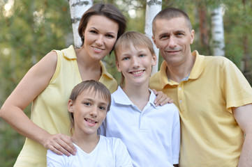 family relaxing on the grass in the park