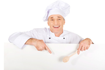 Chef in white uniform holding empty banner