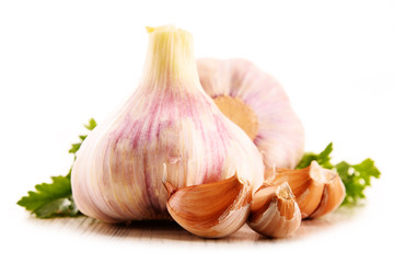 Composition with bulbs of garlic isolated on white