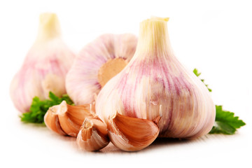 Composition with bulbs of garlic isolated on white