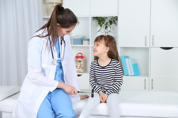 Little girl and young doctor in hospital