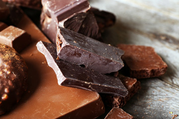 Set of chocolate on wooden table, closeup