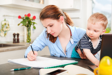 Young mother working with her baby 