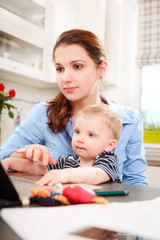 Young mother working with her baby 