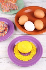 Decoration Easter eggs with colorful beads on wooden table, closeup