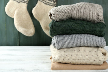 Knitting clothes on wooden background