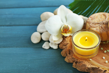 Still life with beautiful blooming orchid flower, spa treatment on wooden background