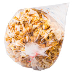 Caramel popcorn in a paper cone pack over white background