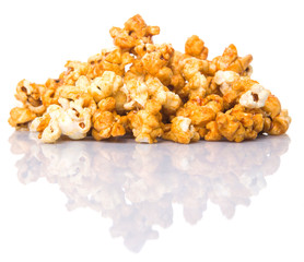 Caramel popcorn over white background © akulamatiau