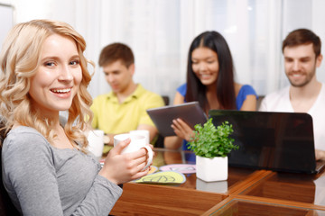 Blond girl and her team of developers