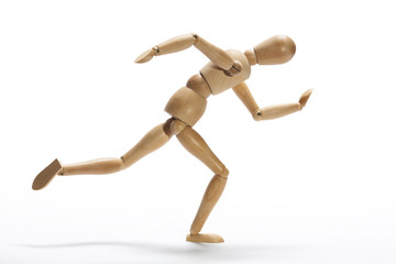 Wooden mannequin in intense sprint on a white background
