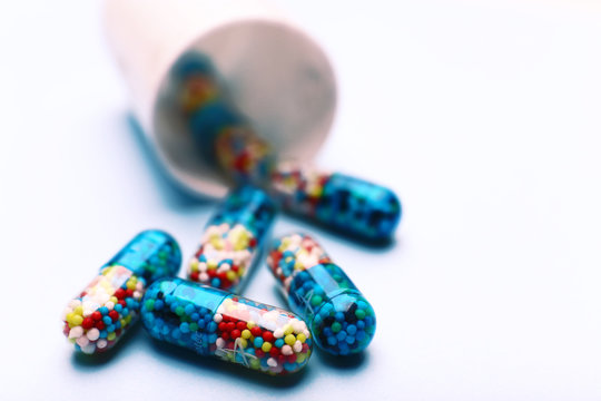 Heap of pills on color background