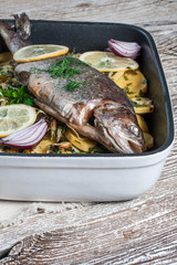 Baked trout with potatoes.