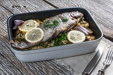Baked trout with potatoes.
