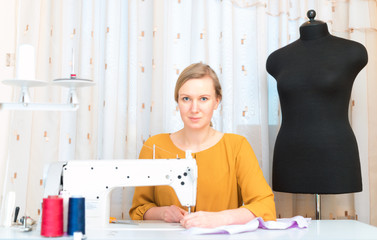 Woman working on sewing machine in the factory.