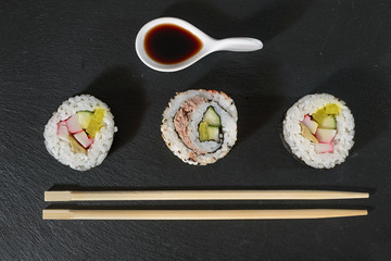 sushi pieces with soy sauce and chopsticks