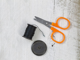 Sewing objects on rustic white wood