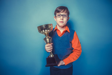 European-looking  boy of  ten years in glasses holding a cup, aw