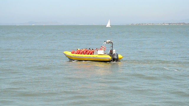 resque  yellow boat (vessel) on the azure sea waves in sunny day, travel diversity