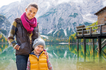 Fototapeta na wymiar Smiling mother and blonde daughter posing at Lake Bries