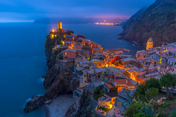 City on the rocks at night Liguria Italy