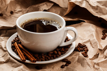 Cup of coffee over crumpled paper