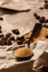 Spoon with brown sugar and coffee beans