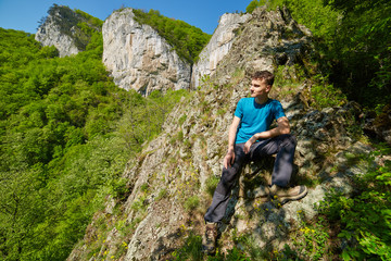 Naklejka na ściany i meble Teenager boy posing on the mountains