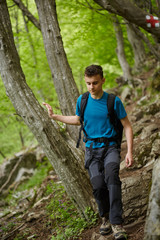 Naklejka na ściany i meble Teenager hiker on a mountain trail