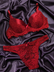 Red lacy lingerie on black background