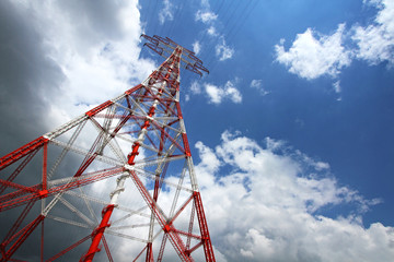 High-voltage Pylon with 380 Kv High-voltage Lines in Front of a Blue Sky with White Clouds at the...