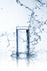 Fresh drink with splashing stream of water