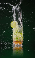 Fresh mojito drink with ice cubes and splashes