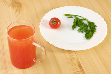 Red tomato and a glass of juice