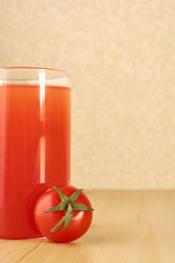 Red tomato and a glass of juice