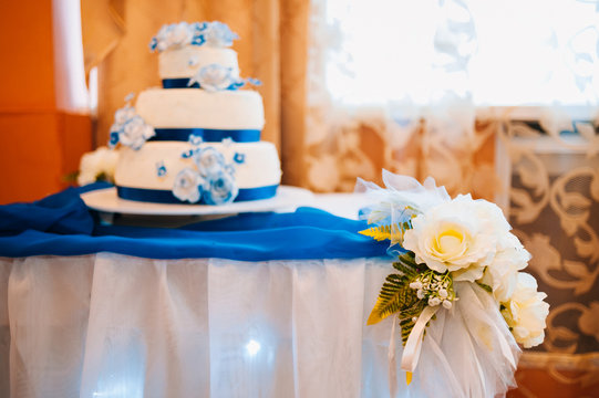 Multi Level White Wedding Cake On Silver Base And Pink Flowers