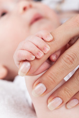Newborn hands holding mothers hand