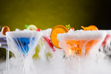 Cocktails with ice vapor on bar desk