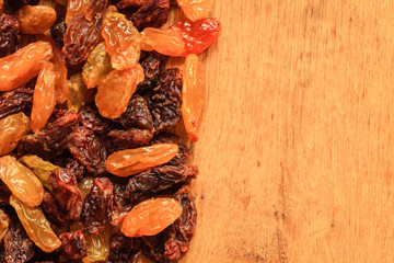  Border frame of raisin on wooden background