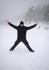 Man standing in the snow at woods