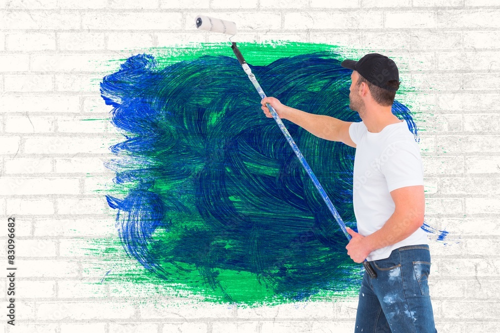 Poster composite image of handyman painting with roller