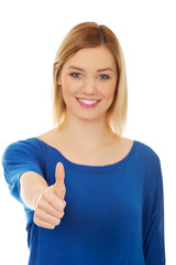Young woman showing thumbs up.