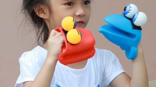 girl playing hand puppet