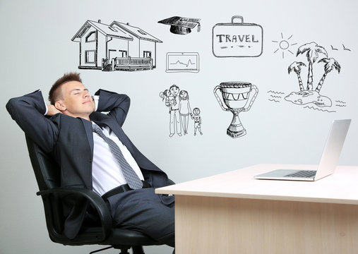 Dreaming concept. Portrait of young businessman in office